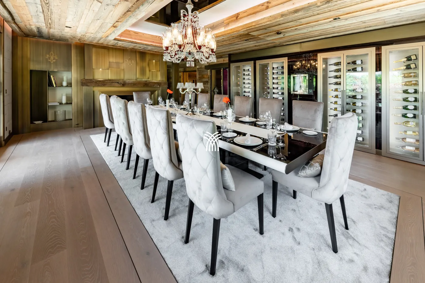 Long dining table set under a crystal chandelier at Chalet Christiana