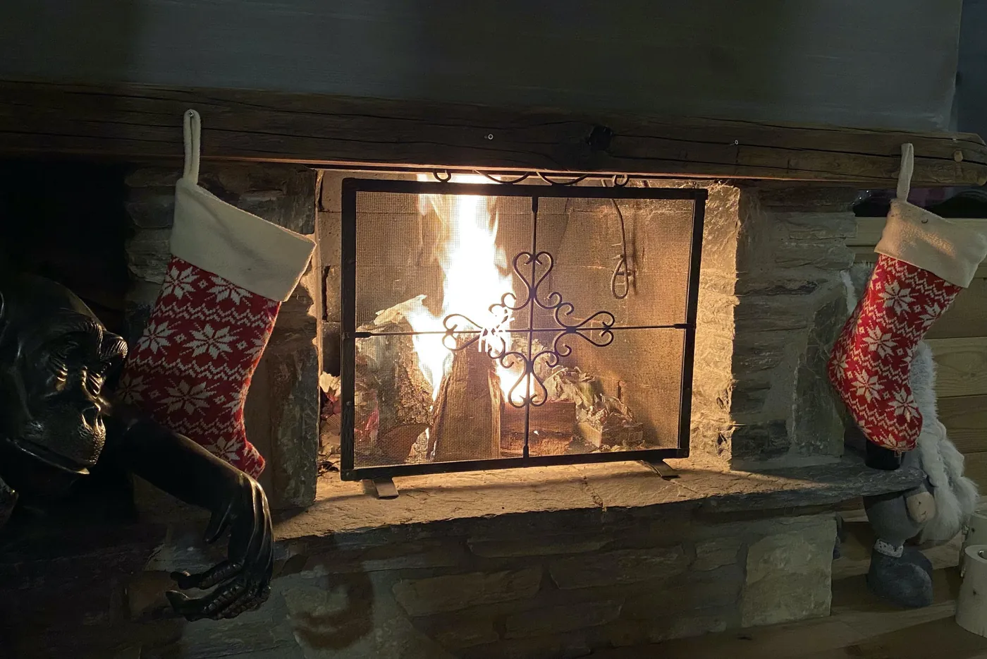 A lit fireplace in the living room of Chalet Cervo, Crans-Montana
