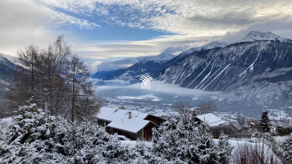 Winter view over the Alps from a chalet terrace in Crans-Montana