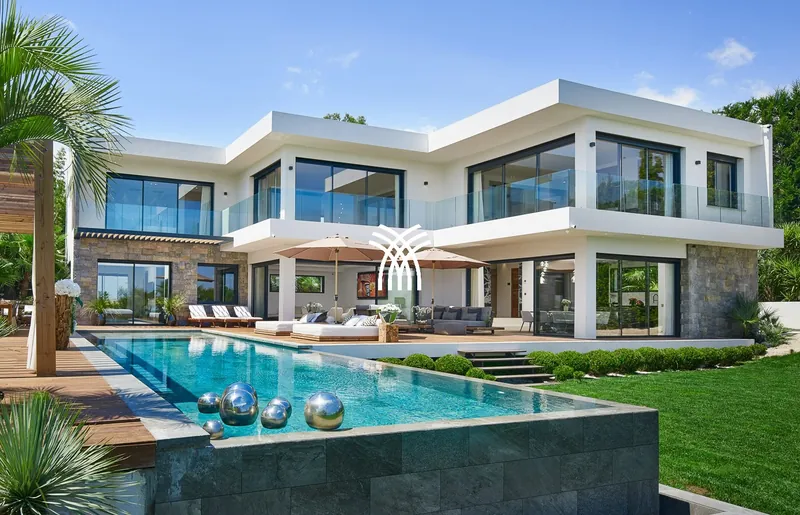 White modern Villa Mila with infinity pool and palm tree